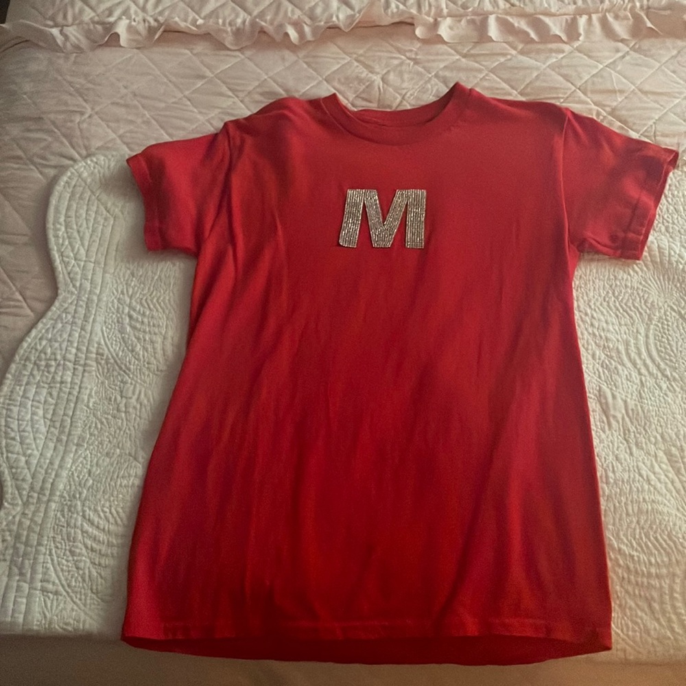 Red T-shirt with a sparkly M on it